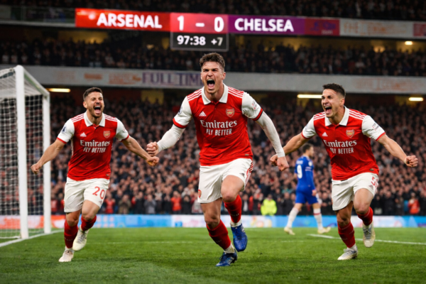 Arsenal celebrating late winner against Chelsea in EFL Cup semi-final at Stamford Bridge.